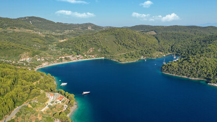 Aerial drone photo of famous crystal clear turquoise beach and bay of Panormos a popular safe sail...
