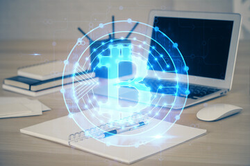 Multi exposure of blockchain theme hologram and table with computer background. Concept of bitcoin crypto currency.