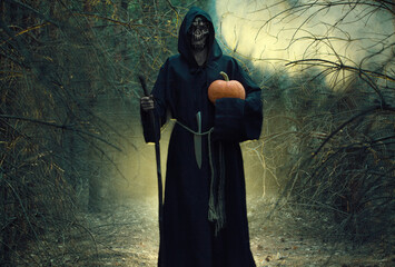 Woman devil ghost demon costume horror and scary she holding pumpkin in hand in the forest. The...