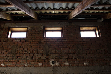 the old brick wall with three windows