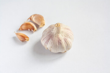 Garlic head and three cloves isolated on a white background