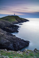 Fototapeta na wymiar Strumble Head Lighthouse, Pembrokeshire, at sunset