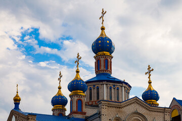 Fototapeta na wymiar Domes of the Kislyakovskaya Church of the Nativity of the Blessed Virgin Mary against the background of a cloudy sky (Krasnodar Territory, Russia)