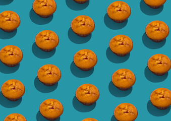 Set of tasty ruddy muffin cakes filler with jam over blue background