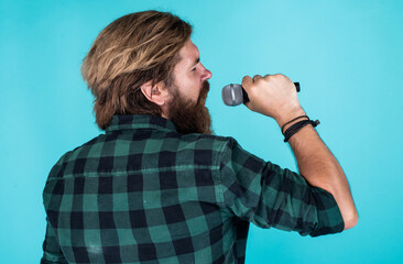 catch the tune. mature charismatic male vocalist. guy with beard singing in microphone. confidence...