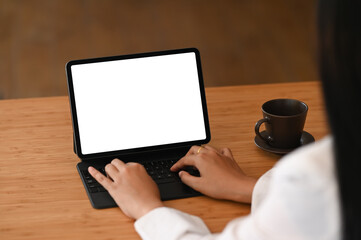 Business woman using digital tablet on wooden table at her office.