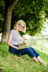 Girl laptop outdoors. Why employees need to work outdoors. Being outdoors exposes workers to fresher air and environmental variations making happy and healthy on physical and emotional level