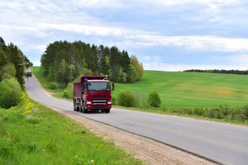 Tipper Dump Truck transported sand from the quarry on driving along highway. Modern Heavy Duty Dump...