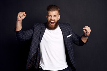 Body language. Beautiful strong bearded caucasian man expressive gesticulating with hands, screaming loudly on stadium, cheering his favourite rugby or football team in final game