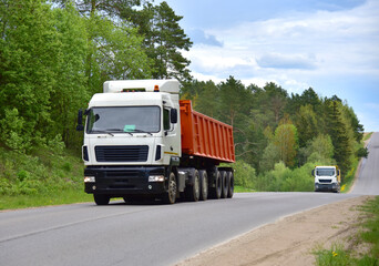 Truck with tipper semi trailer transported sand from the quarry on driving along highway. Modern Dump Semi-Trailer Rear Tipper Truck Trailer © MaxSafaniuk