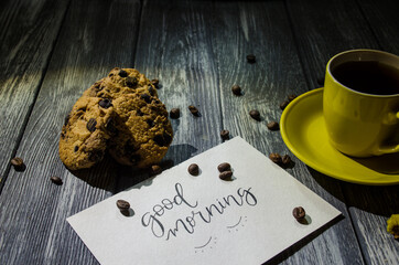 Still life with cup of coffee and chocolate cakes on the grey background