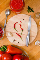 ingredients for making a traditional Georgian hot red sauce - adjika on a wooden table, close-up, flatley