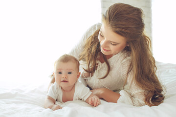 Small child with a woman. Baby with mom. High quality photo.