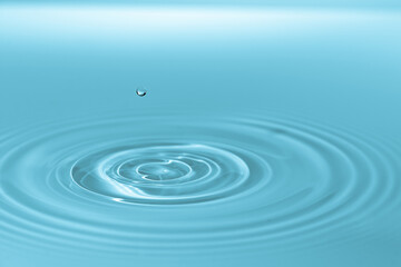 Waves on the surface of the water from a collision. Drop of water drop to the surface.
