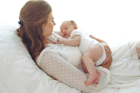 Small child with a woman. Baby with mom. High quality photo.