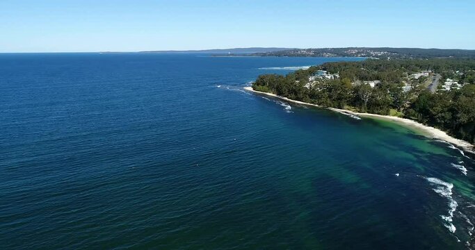 Waterfront of Huskisson town on Jervis bay from cliffs to rock pool and delta.
