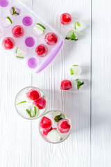 Raspberry and lime in ice cubes top view flat lay