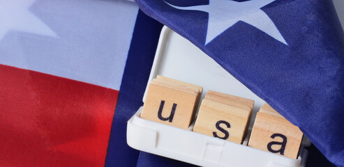 Fototapeta na wymiar USA letters on the background of the flag of America.