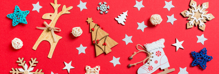 Top view Banner of holiday toys and decorations on red Christmas background. New Year time concept
