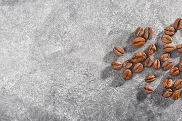 Fototapeta na wymiar Roasted coffee beans. Coffee beans. Aromatic coffee beans. Coffee beans on a gray background.