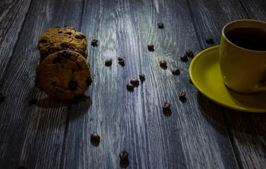 Still life with cup of coffee and chocolate cakes on the grey background