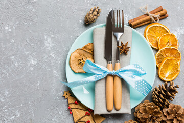 Top view of holiday dinner decorated with dried fruit and cinnamon on cement background. Set of...