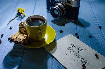 Still life with cup of coffee and chocolate cake on the blue background