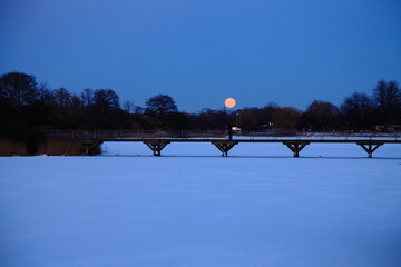 Copenhagen frozen river and city in winter with snow.