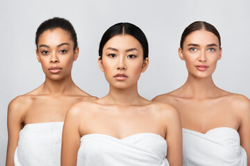 Three Diverse Girls Wrapped In Bath Towels Standing In Studio