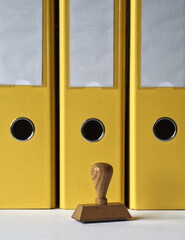 Rubber stamp and yellow document folders