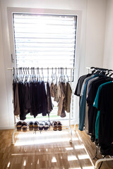 Clothes Hanger on Rack and Shoes with Sunlight in Switzerland.