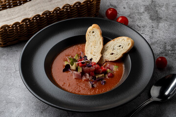 Gourmet tomato cream soup with avocado and raw tuna, posh restaurant gourmet special meal
