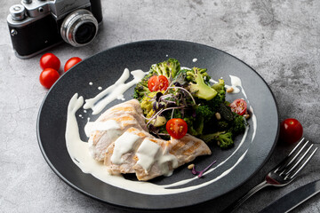 Top view of a healthy restaurant meal: boiled chicken breast, broccoli