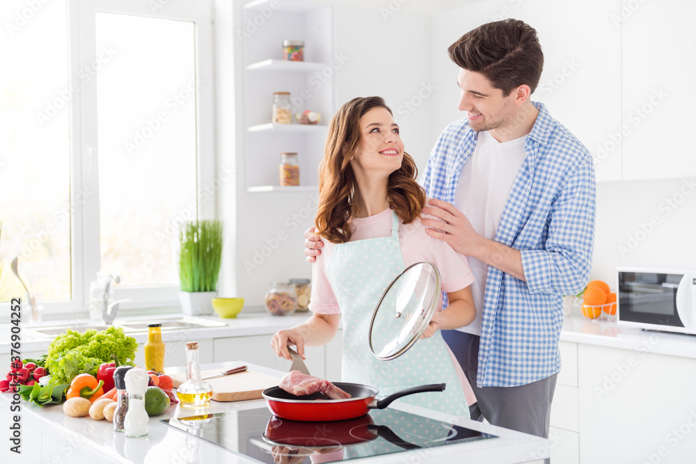 Sticker Two people romantic red hair brown couple enjoy hobby cooking weekend girl prepare raw beef lunch open frying pan cover look affectionate helping husband in kitchen house indoors