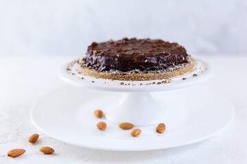 Homemade chocolate almond cake on a white table. Sugar, lactose, gluten free.