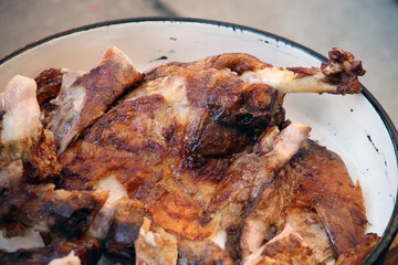 Roast Leg of Lamb. Cooking lamb carcass on a spit over hot charcoals outdoors during the holiday. Traditional Serbian roasting lamb. 