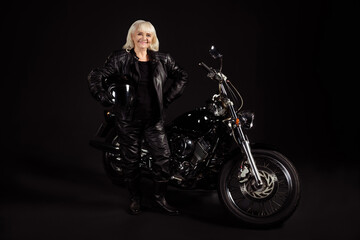 Naklejka na ściany i meble Portrait of her she nice attractive trendy fashionable content cheerful cheery grey-haired lady traveler rebel rocker enjoying freedom club life leisure hobby isolated over black color background