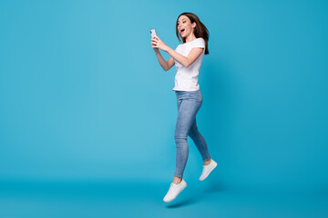 Full length body size view of her she attractive slim fit glad cheerful girl blogger jumping using...