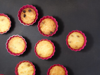 Fresh homemade delicious blackberry muffins on dark background. Top view