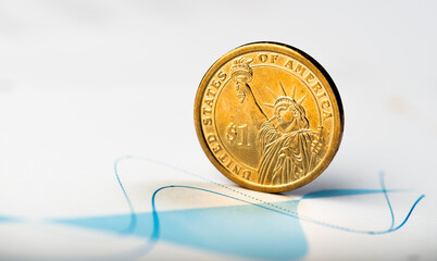 One dollar coin on fluctuating graph