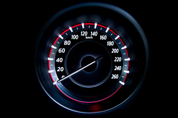 light with car mileage with black background,number of speed,Odometer of car.	