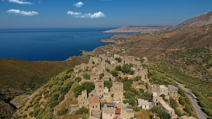 Obraz premium Aerial drone photo of picturesque abandoned old stone tower village of Vatheia overlooking deep blue sea in Mani Peninsula, Peloponnese, Greece