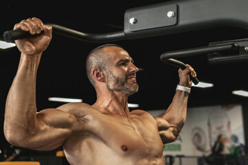 Muscular bodybuilder during his workout in the gym