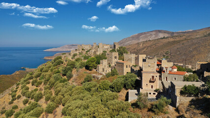 Fototapeta premium Aerial drone photo of picturesque abandoned old stone tower village of Vatheia overlooking deep blue sea in Mani Peninsula, Peloponnese, Greece