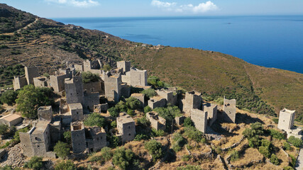 Fototapeta premium Aerial drone photo of picturesque abandoned old stone tower village of Vatheia overlooking deep blue sea in Mani Peninsula, Peloponnese, Greece