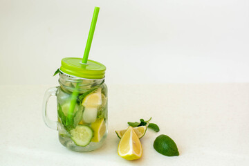 Health care, fitness, healthy nutrition diet concept. Fresh cool lemon cucumber mint infused water, cocktail, detox drink, lemonade in a glass jar.
