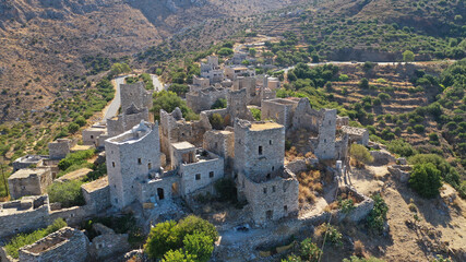 Fototapeta na wymiar Aerial drone photo of picturesque abandoned old stone tower village of Vatheia overlooking deep blue sea in Mani Peninsula, Peloponnese, Greece