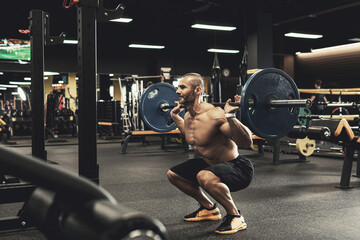 Fototapeta Bodybuilder during his workout with a barbell in the gym obraz