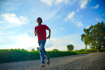 Happy indian child running on road