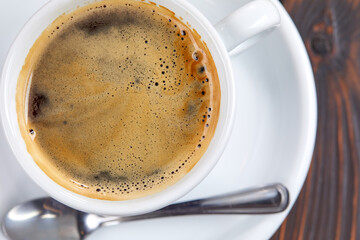 cup of coffee on the wooden background
